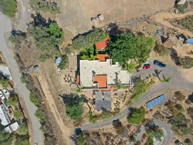 an aerial view of residential house with an outdoor space and seating