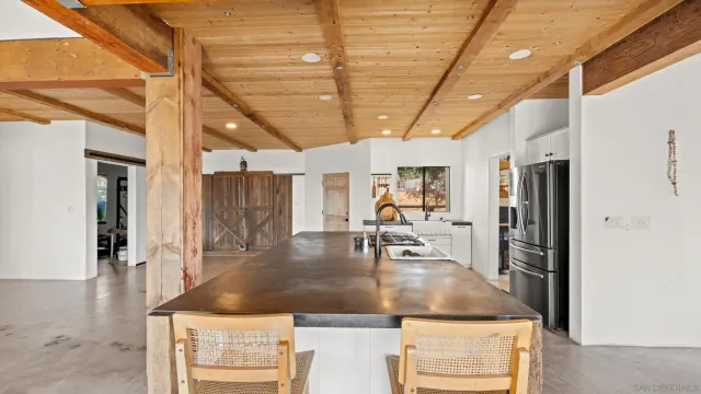 a kitchen with stainless steel appliances granite countertop a sink a stove and a refrigerator