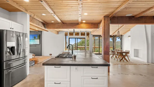 a kitchen with a sink a refrigerator and wooden floor
