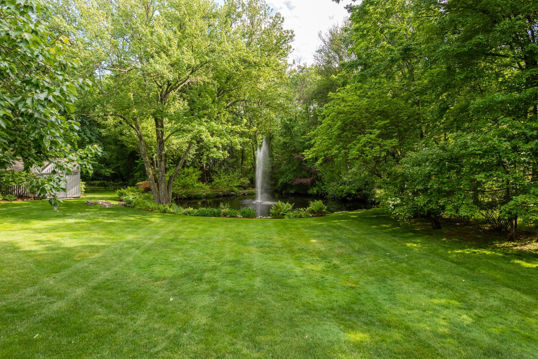20 St Nicholas Road Darien, CT 06820 - Photo 18 of 38 a view of a backyard with large trees