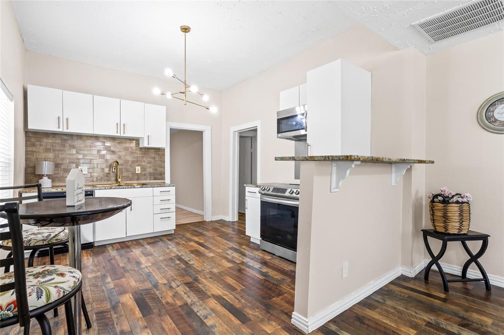 614 Rice Street Denison, TX 75020 - Photo 11 of 22 Here the dining and kitchen areas are defined. Once the refrigerator is in, the table coud be moved tothe area beside the bar.