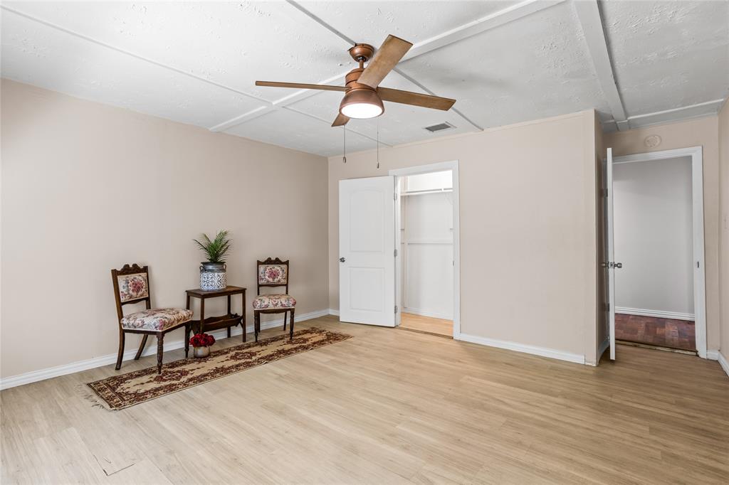 614 Rice Street Denison, TX 75020 - Photo 16 of 22 This room has a large closet that follows the whole wall to the exit door on the right.