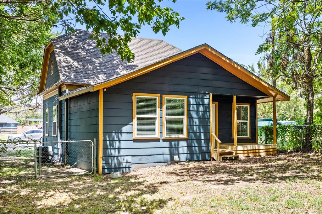 614 Rice Street Denison, TX 75020 - Photo 20 of 22 A large gate allows you to get a large lawnmower in the back yard. The gravel road on the side is ued for parking.