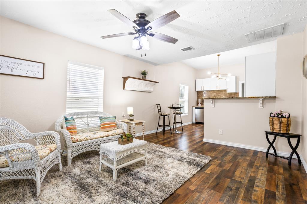 614 Rice Street Denison, TX 75020 - Photo 2 of 22 Step into an updated home that starts in this living area with wood flooring.