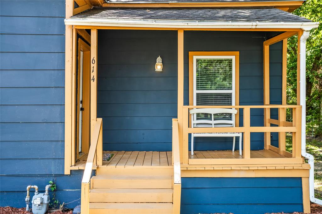 614 Rice Street Denison, TX 75020 - Photo 7 of 22 The front covered porch welcomes you and protects you from the weather.