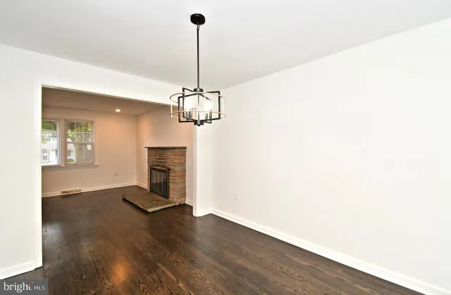 a view of a room with wooden floor and windows
