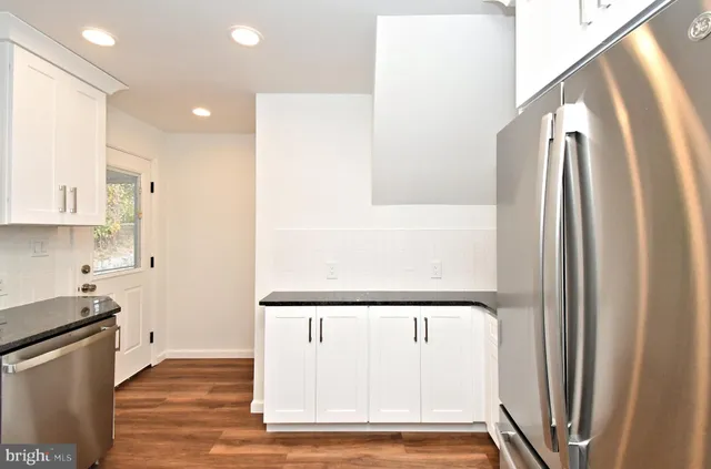a kitchen with stainless steel appliances a sink stove and microwave
