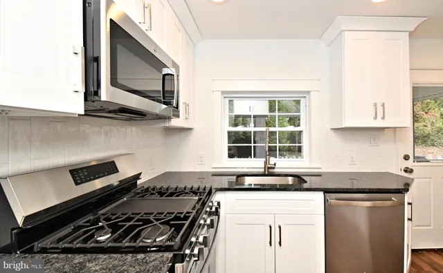 a kitchen with stainless steel appliances a refrigerator stove and microwave