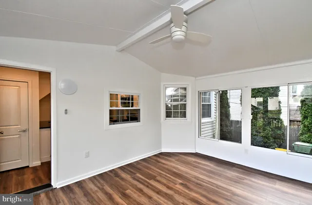 a view of a room with wooden floor and window