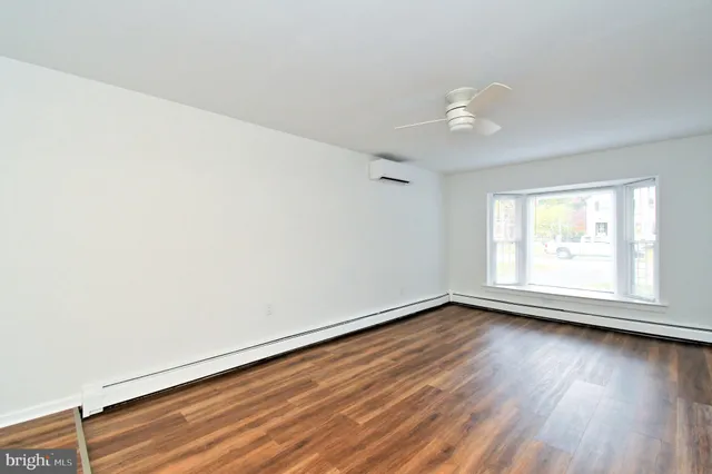 wooden floor in an empty room with a window