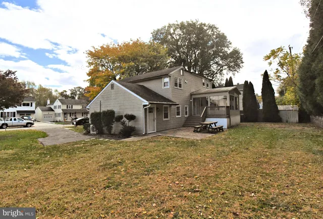 a view of a livingroom with wooden floor and a fireplace