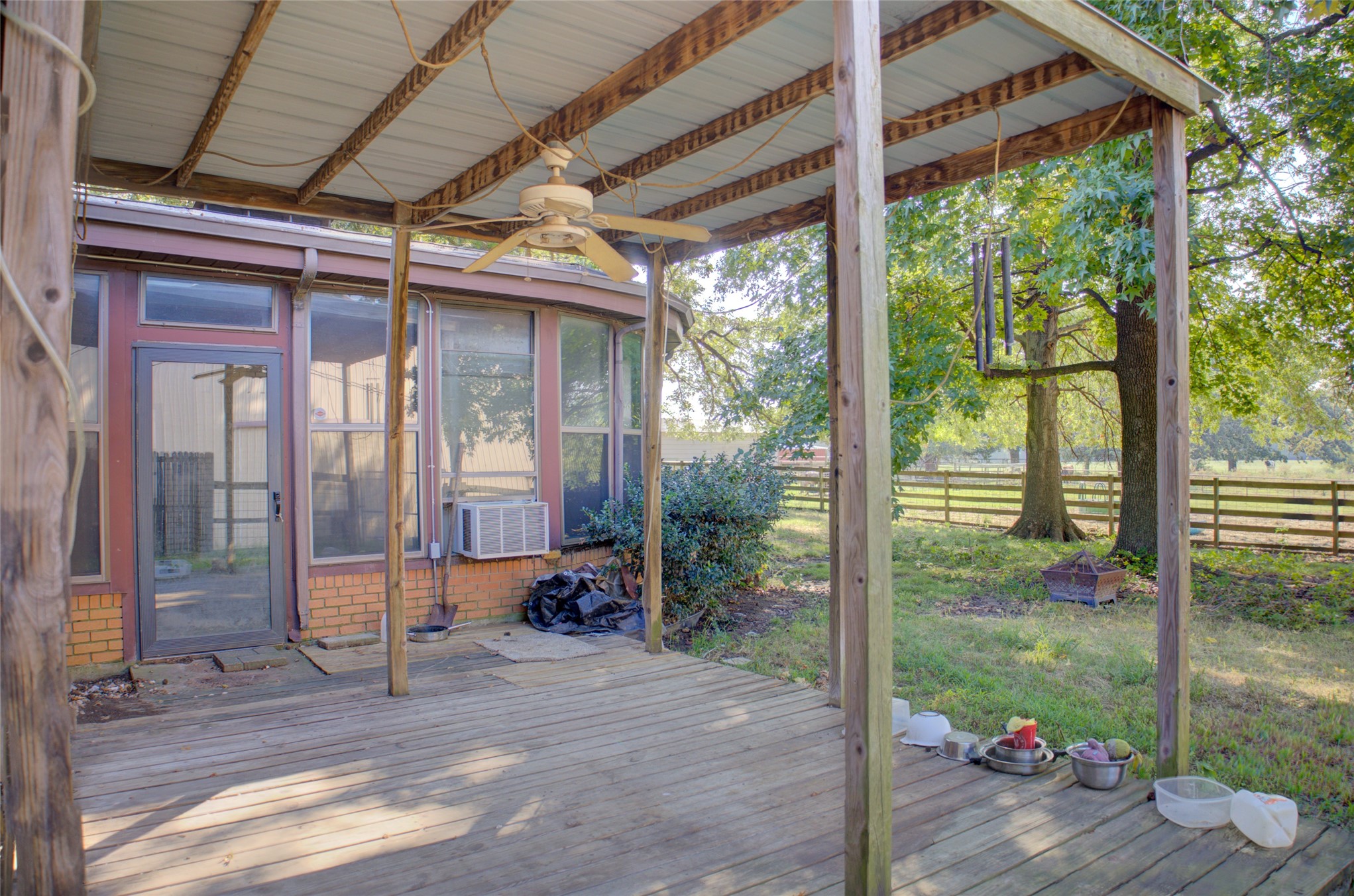 12420 South Garnett Road Broken Arrow, OK 74011 - Photo 41 of 44 Expansive wood deck with a covered patio, ceiling fan, and direct access to an enclosed sunroom featuring multiple windows