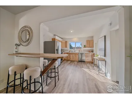 a living room with kitchen island furniture and a wooden floor