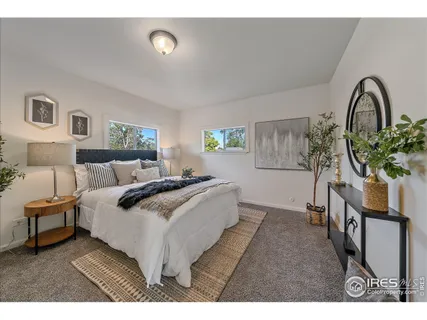 a spacious bedroom with a bed and a potted plant