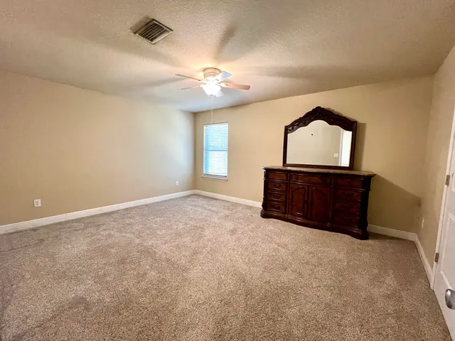 a view of a livingroom with wooden floor and kitchen space with a sink