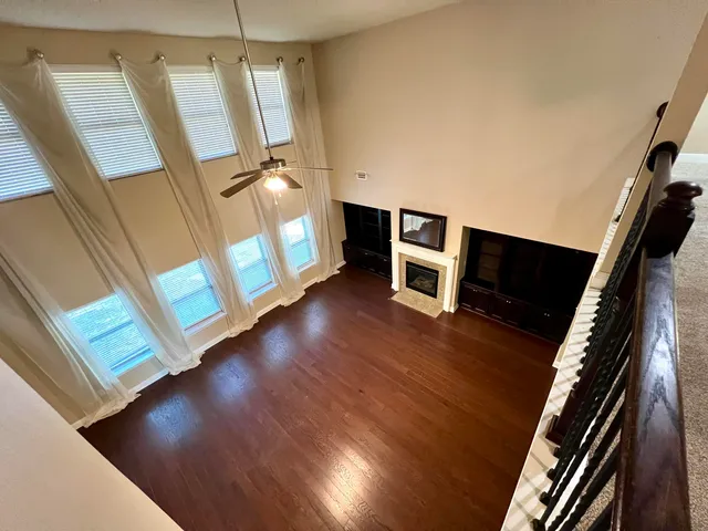 a kitchen with stainless steel appliances granite countertop a stove top oven a sink a dining table and chairs