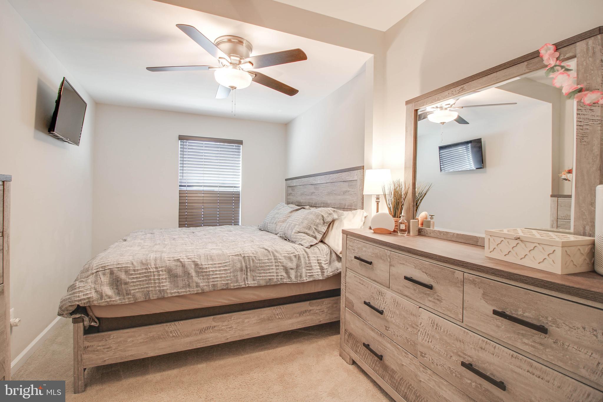 7805 Outing Avenue Pasadena, MD 21122 - Photo 12 of 51 a bedroom with a bed and a chandelier