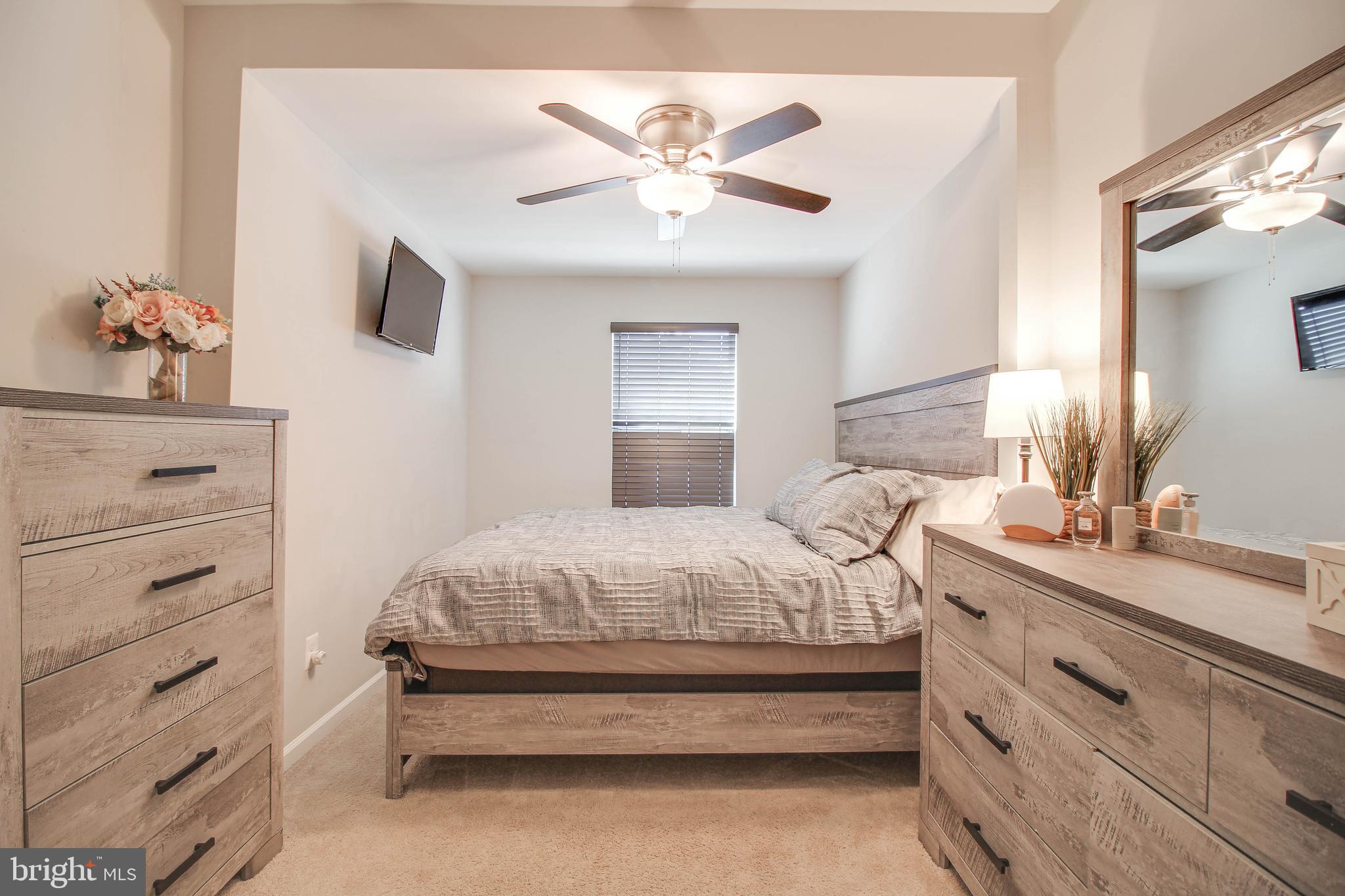7805 Outing Avenue Pasadena, MD 21122 - Photo 13 of 51 a bedroom with a bed and a dresser