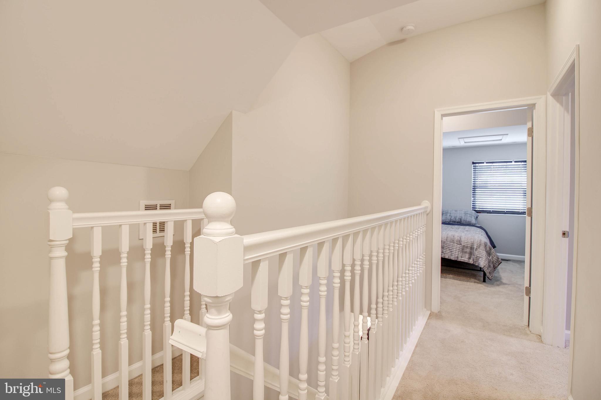 7805 Outing Avenue Pasadena, MD 21122 - Photo 18 of 51 a bedroom with a white bed and a chair