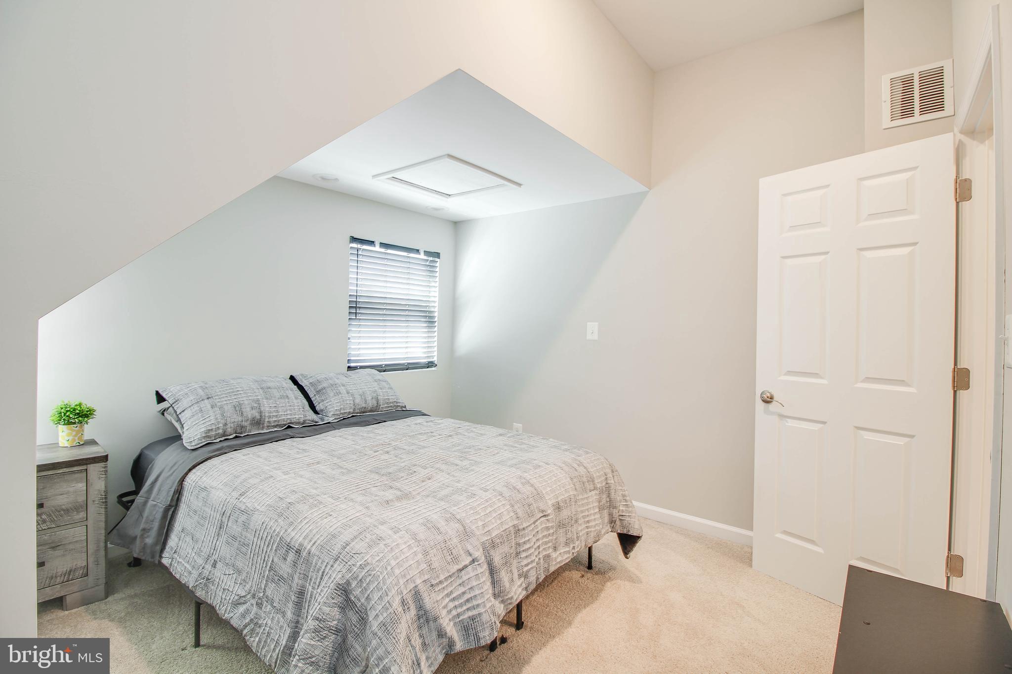 7805 Outing Avenue Pasadena, MD 21122 - Photo 19 of 51 a bedroom with a bed and a window