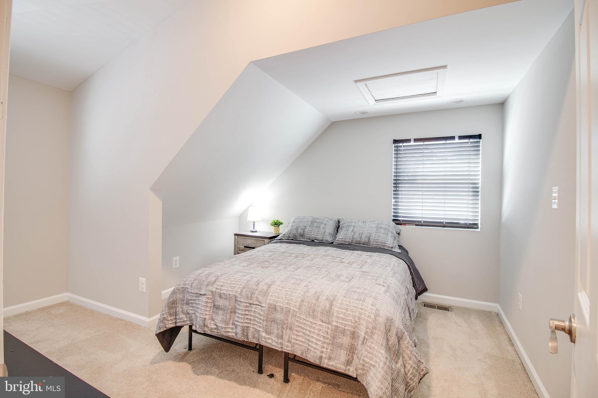 7805 Outing Avenue Pasadena, MD 21122 - Photo 20 of 51 a bedroom with a bed and a window