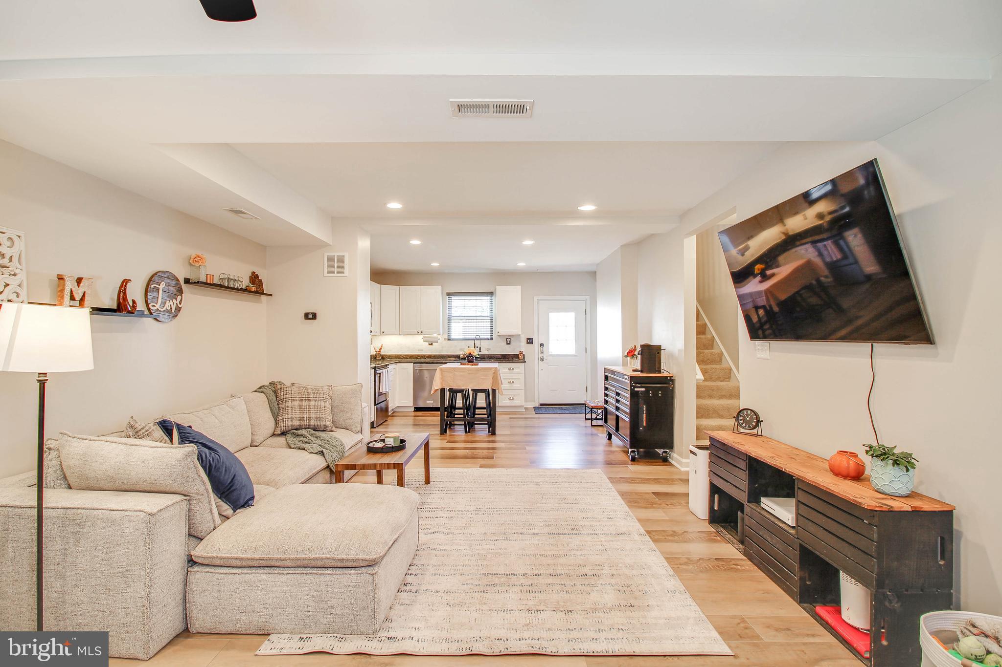 7805 Outing Avenue Pasadena, MD 21122 - Photo 2 of 51 a living room with furniture and a flat screen tv