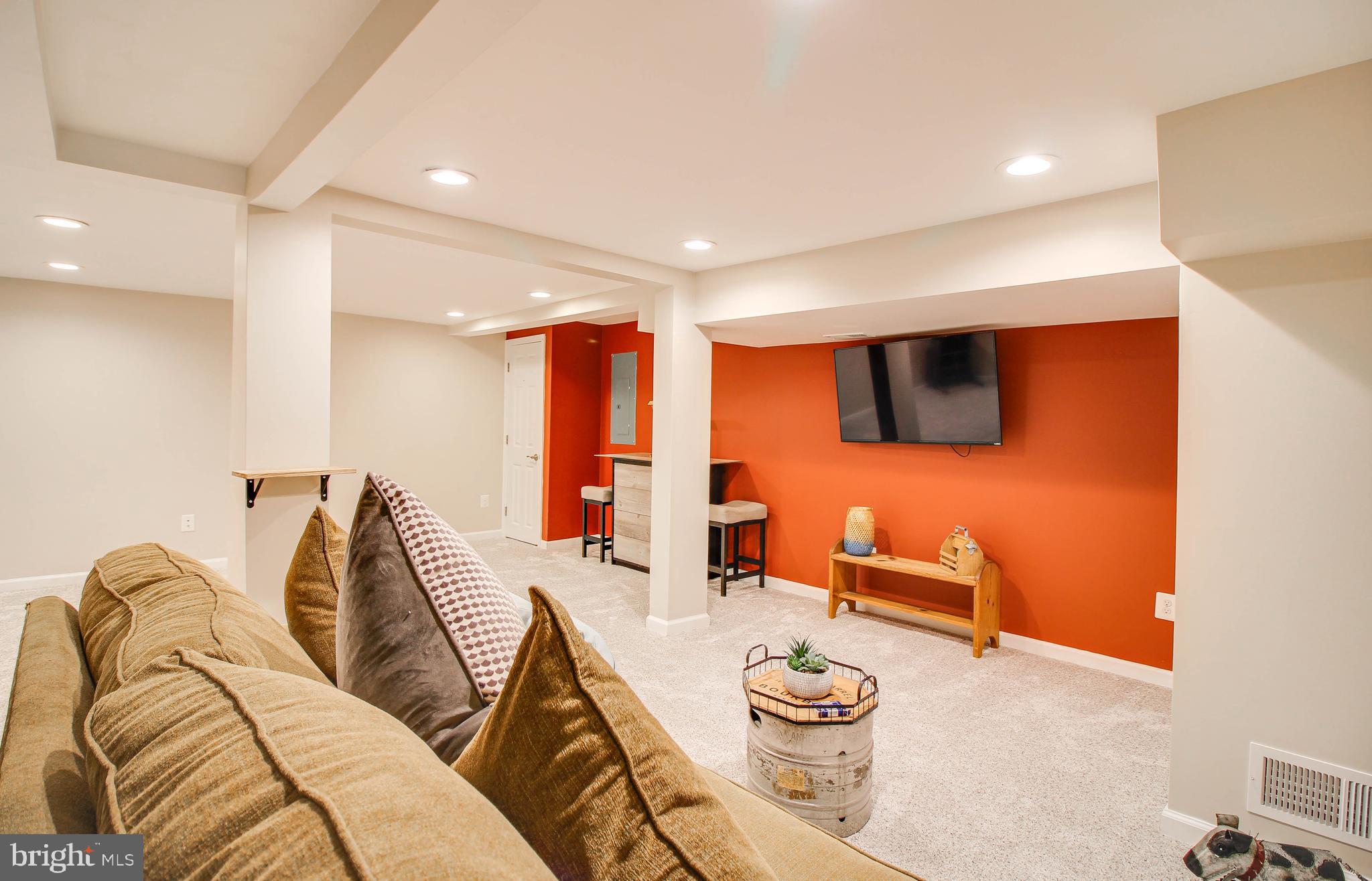 7805 Outing Avenue Pasadena, MD 21122 - Photo 29 of 51 a living room with furniture and a flat screen tv