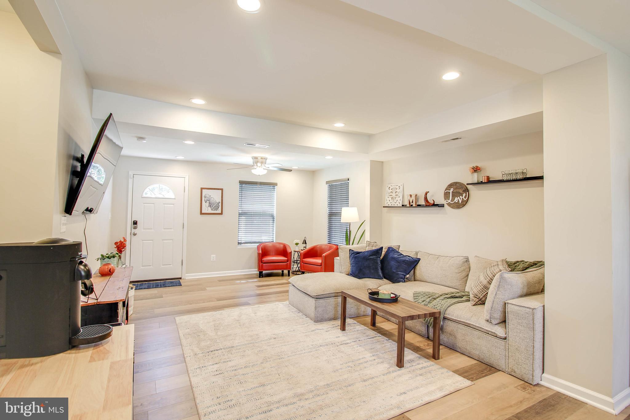 7805 Outing Avenue Pasadena, MD 21122 - Photo 6 of 51 a living room with furniture and a flat screen tv