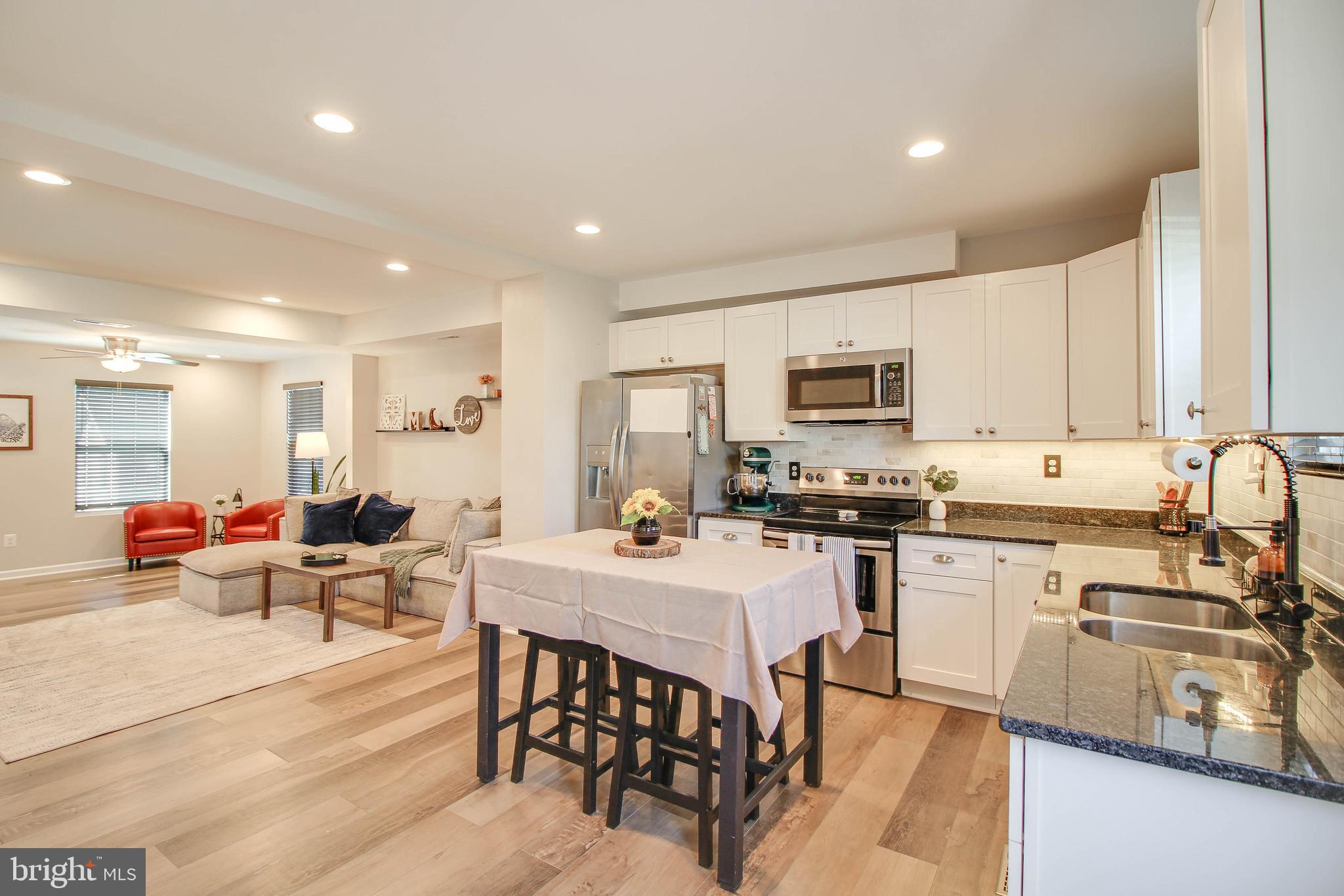 7805 Outing Avenue Pasadena, MD 21122 - Photo 8 of 51 a large kitchen with a table and chairs