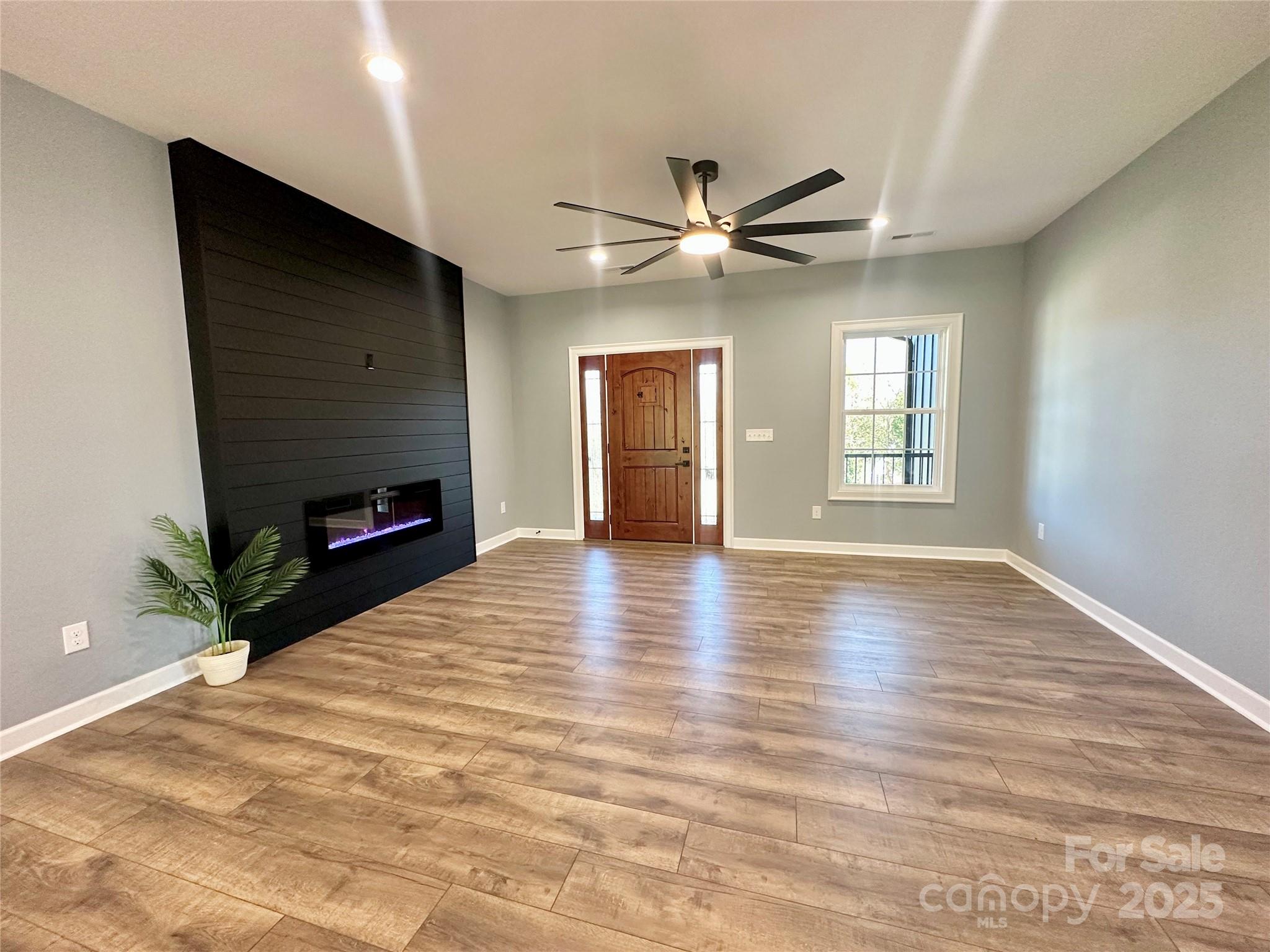2667 Polo Lane Maiden, NC 28650 - Photo 12 of 36 a view of livingroom with window fireplace and wooden floor