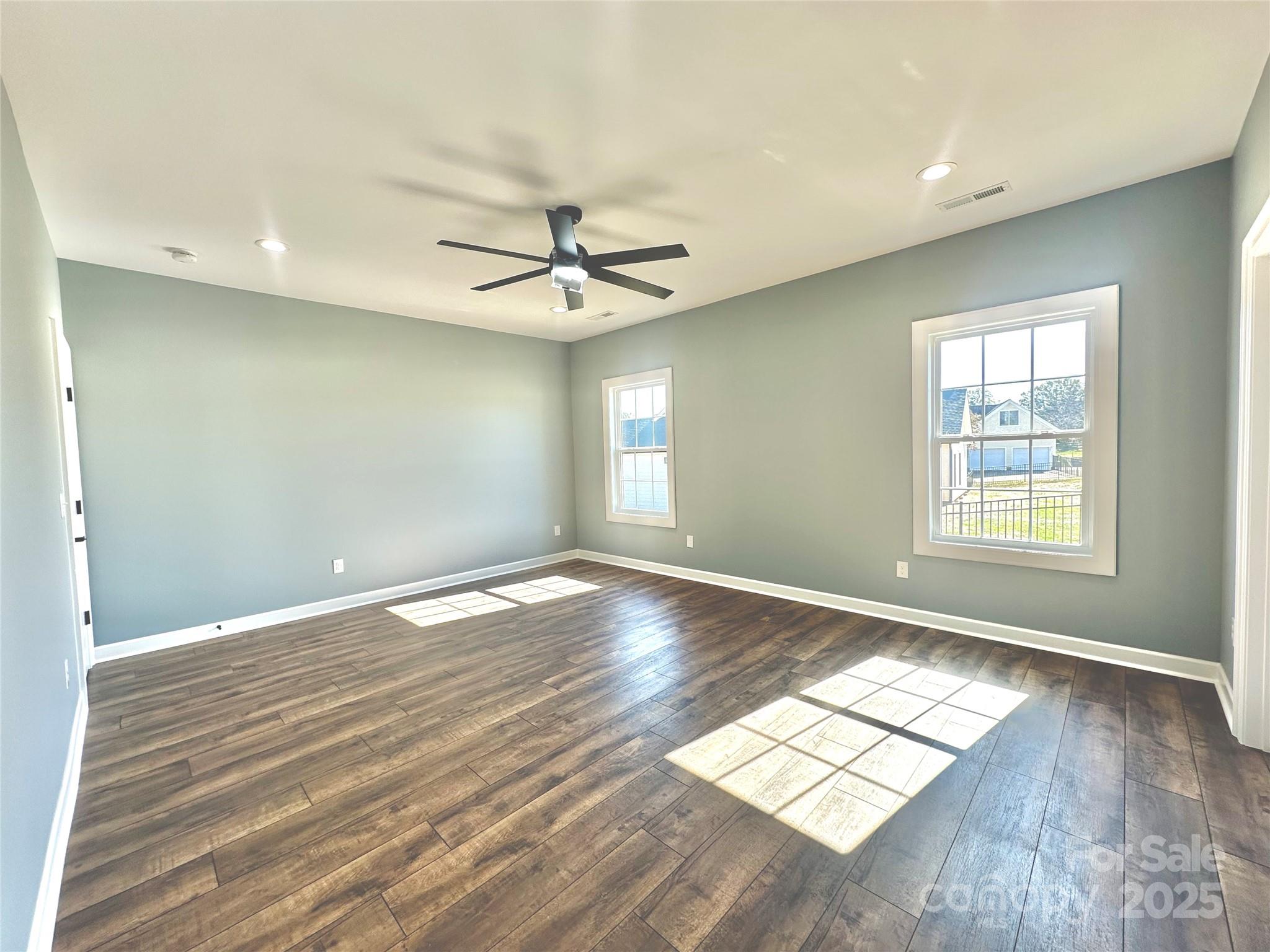 2667 Polo Lane Maiden, NC 28650 - Photo 15 of 36 an empty room with wooden floor and windows