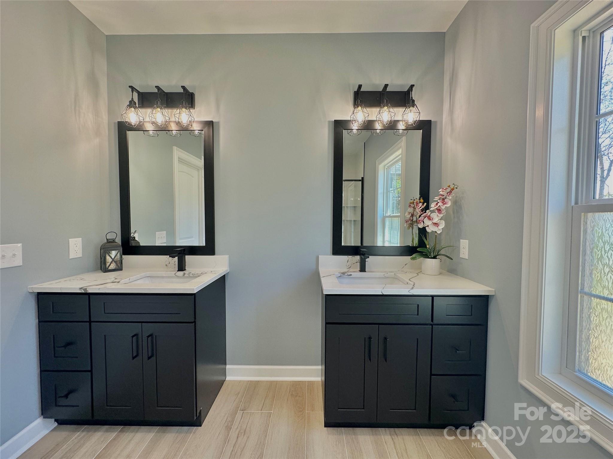 2667 Polo Lane Maiden, NC 28650 - Photo 17 of 36 a bathroom with a double vanity sink and a mirror