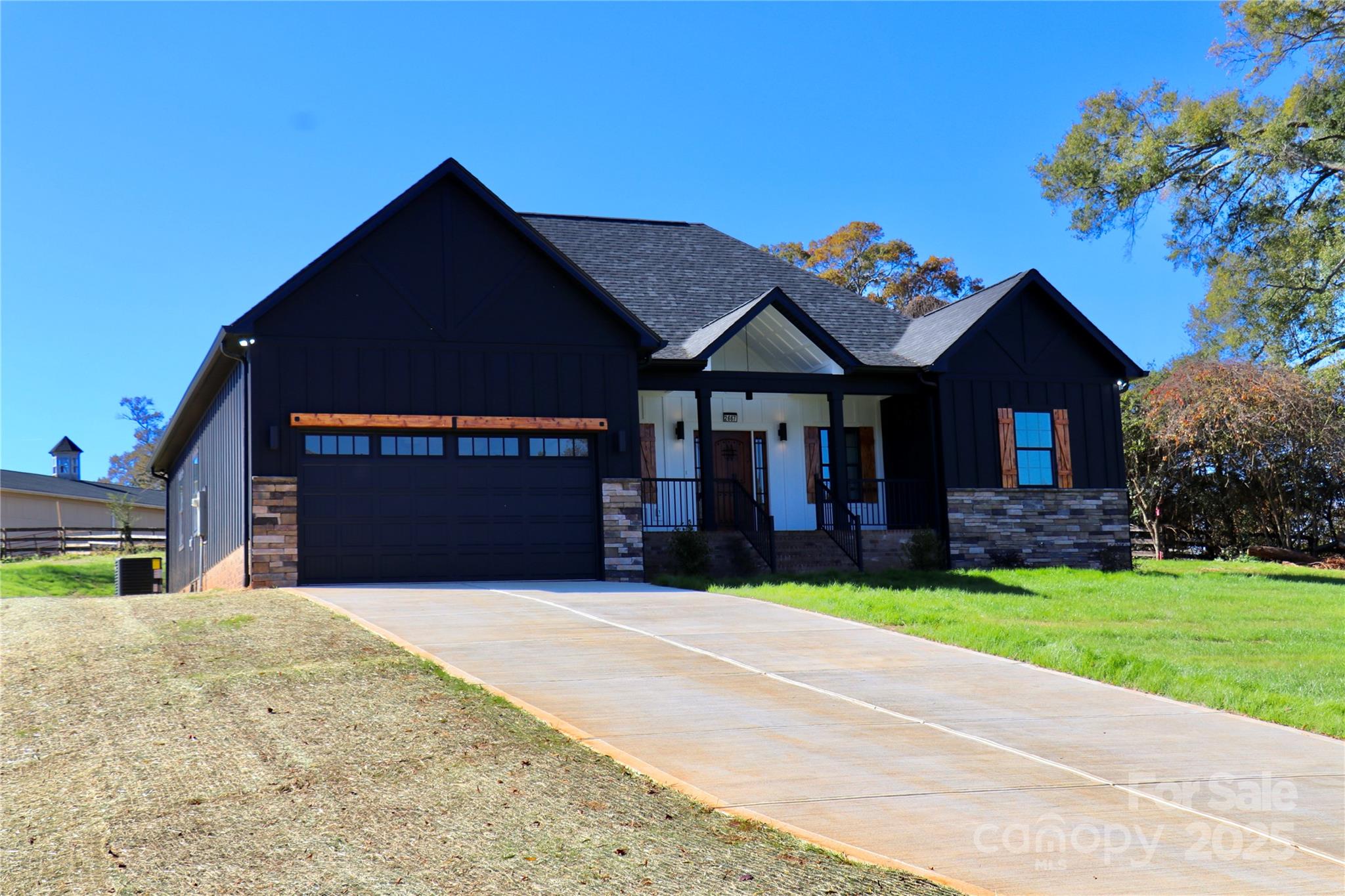 2667 Polo Lane Maiden, NC 28650 - Photo 2 of 36 a front view of a house with a yard and garage