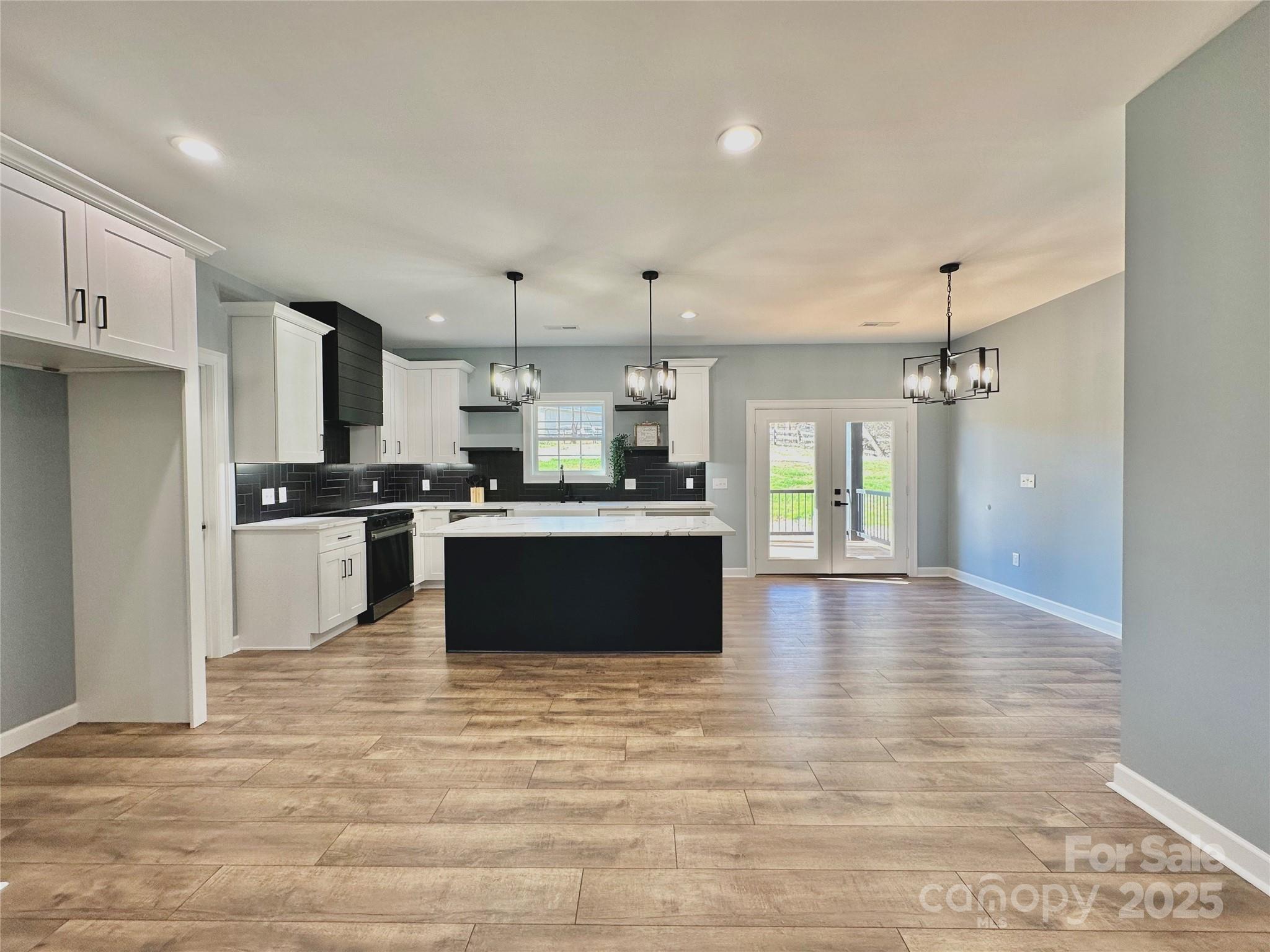 2667 Polo Lane Maiden, NC 28650 - Photo 21 of 36 a large kitchen with kitchen island a sink stainless steel appliances and cabinets