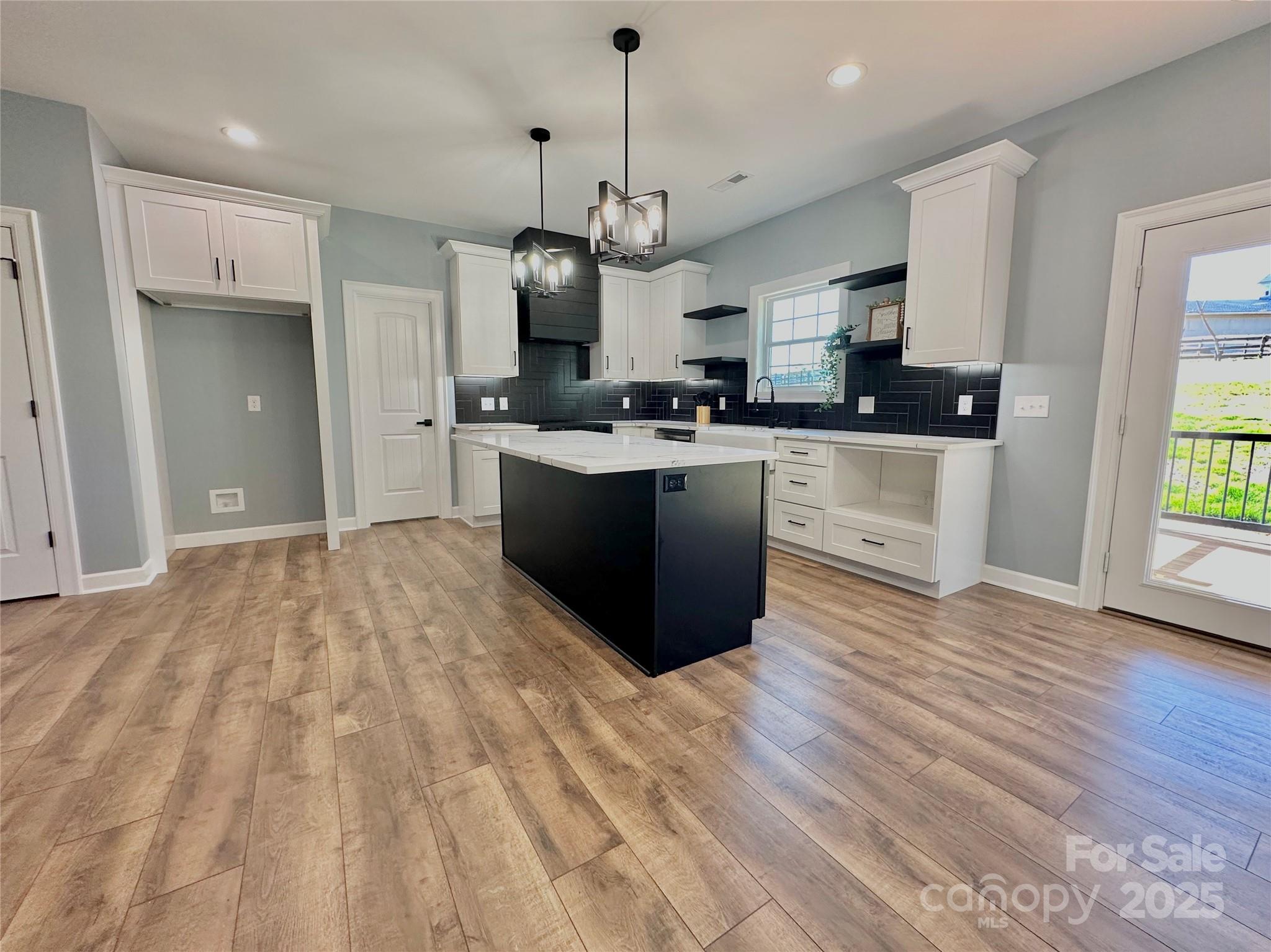 2667 Polo Lane Maiden, NC 28650 - Photo 22 of 36 a large kitchen with stainless steel appliances granite countertop a stove and a sink