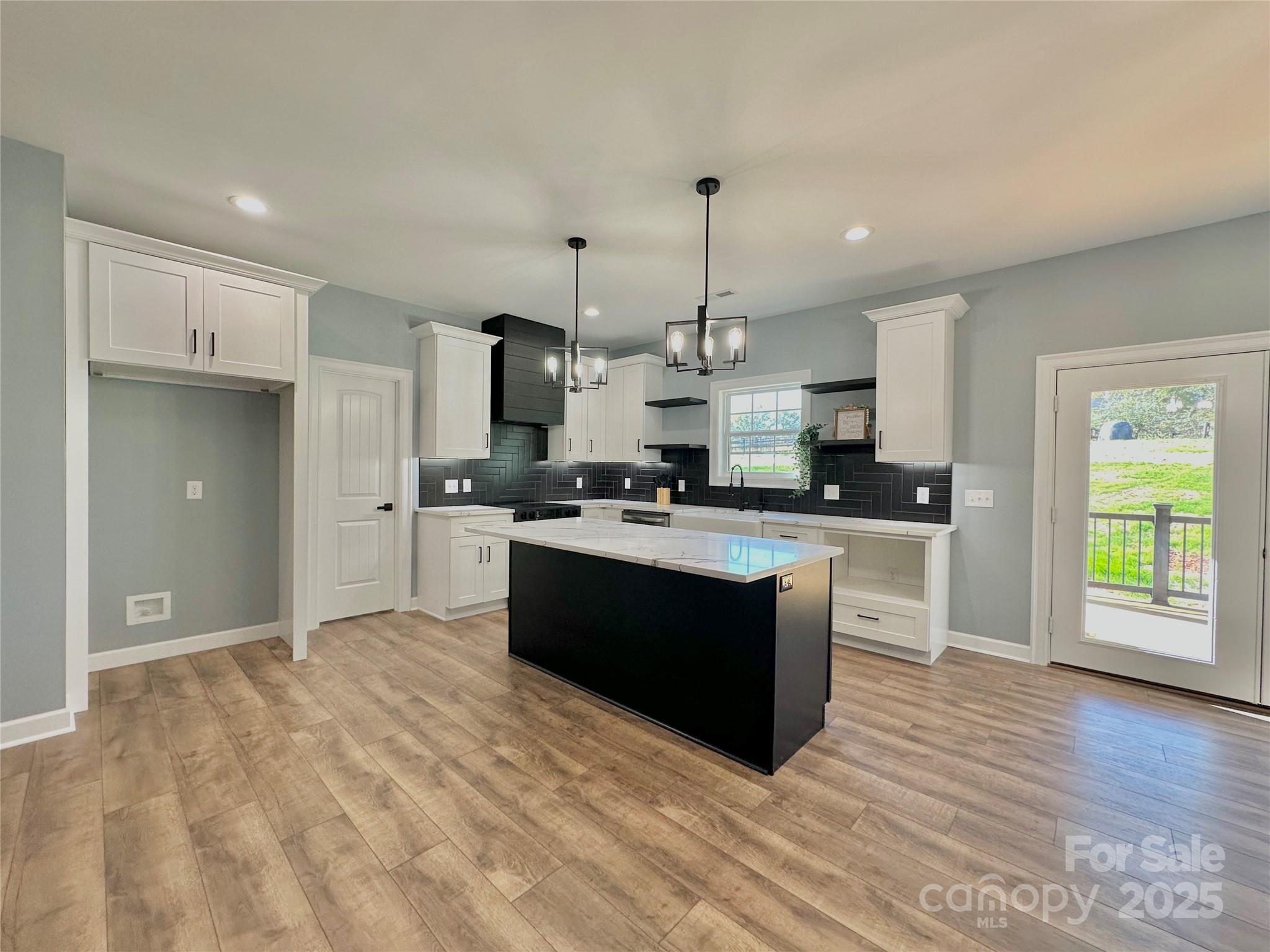2667 Polo Lane Maiden, NC 28650 - Photo 26 of 36 a large kitchen with kitchen island granite countertop a sink window and stainless steel appliances