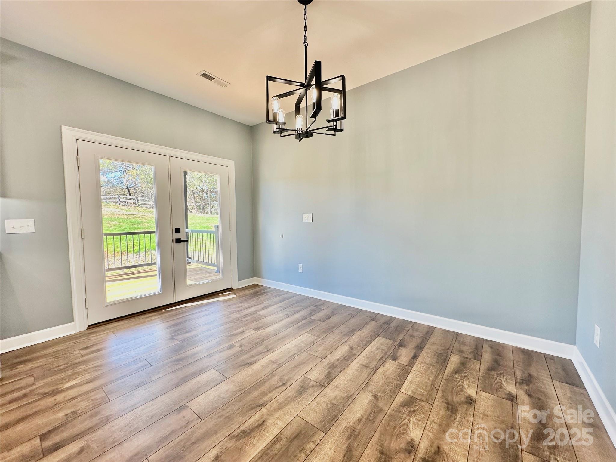 2667 Polo Lane Maiden, NC 28650 - Photo 28 of 36 a view of a room with wooden floor and windows