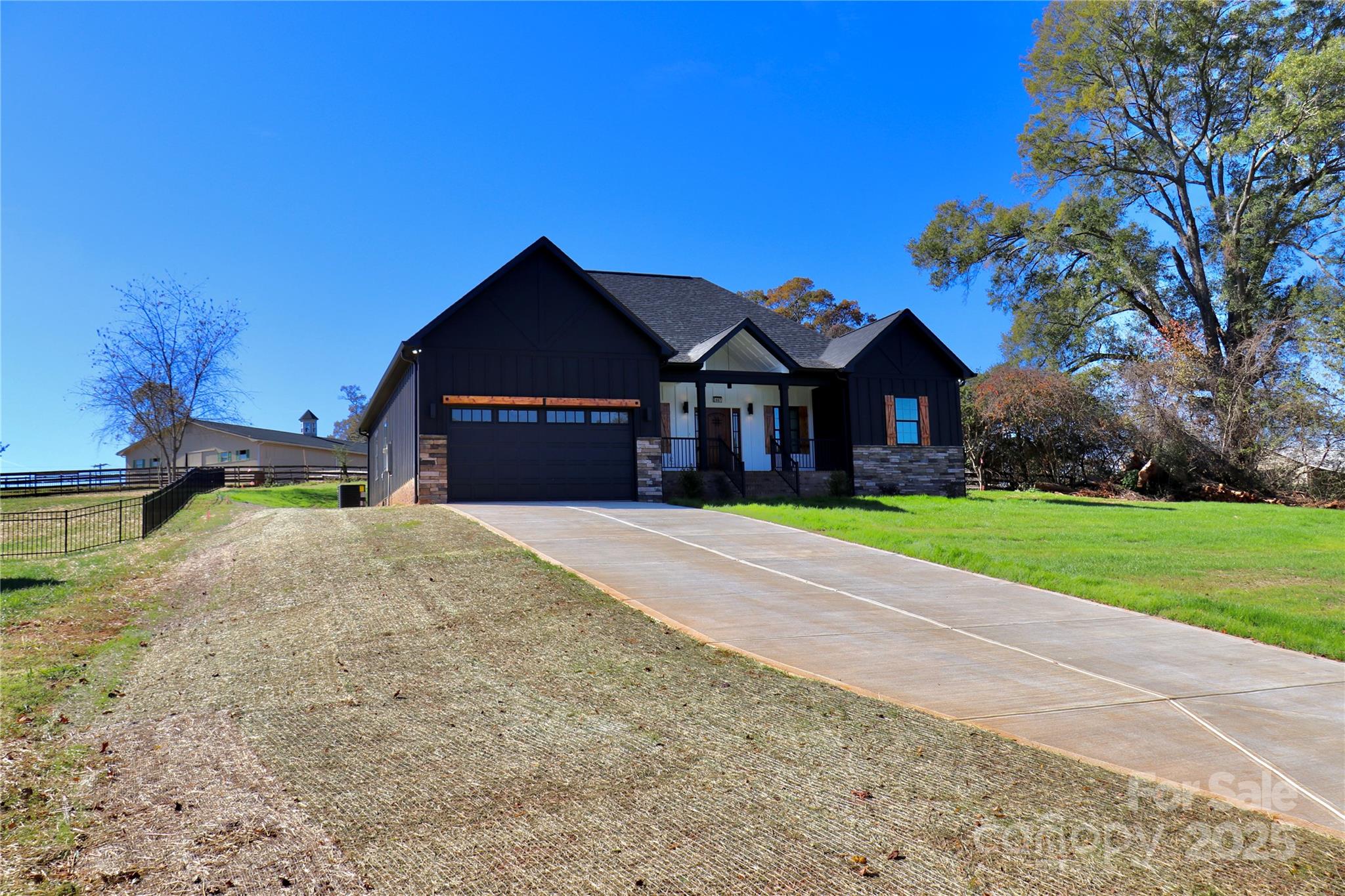2667 Polo Lane Maiden, NC 28650 - Photo 4 of 36 a front view of a house with a yard and garage