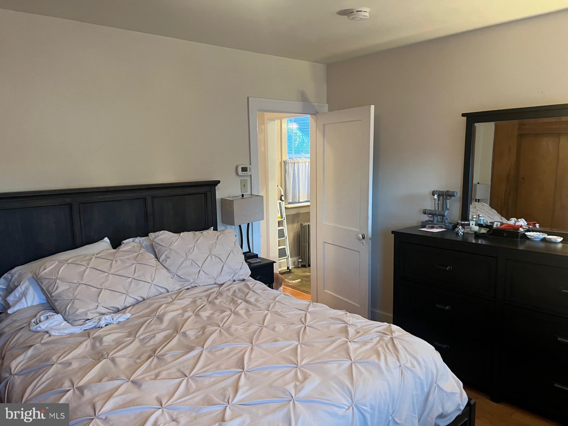 37 North Clinton Street, Unit A Doylestown, PA 18901 - Photo 11 of 11 a bedroom with a bed and a mirror