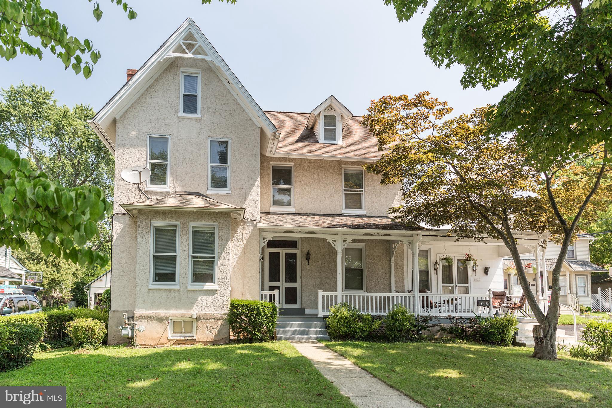 37 North Clinton Street, Unit A Doylestown, PA 18901 - Photo 3 of 11 a front view of a house with a yard and trees