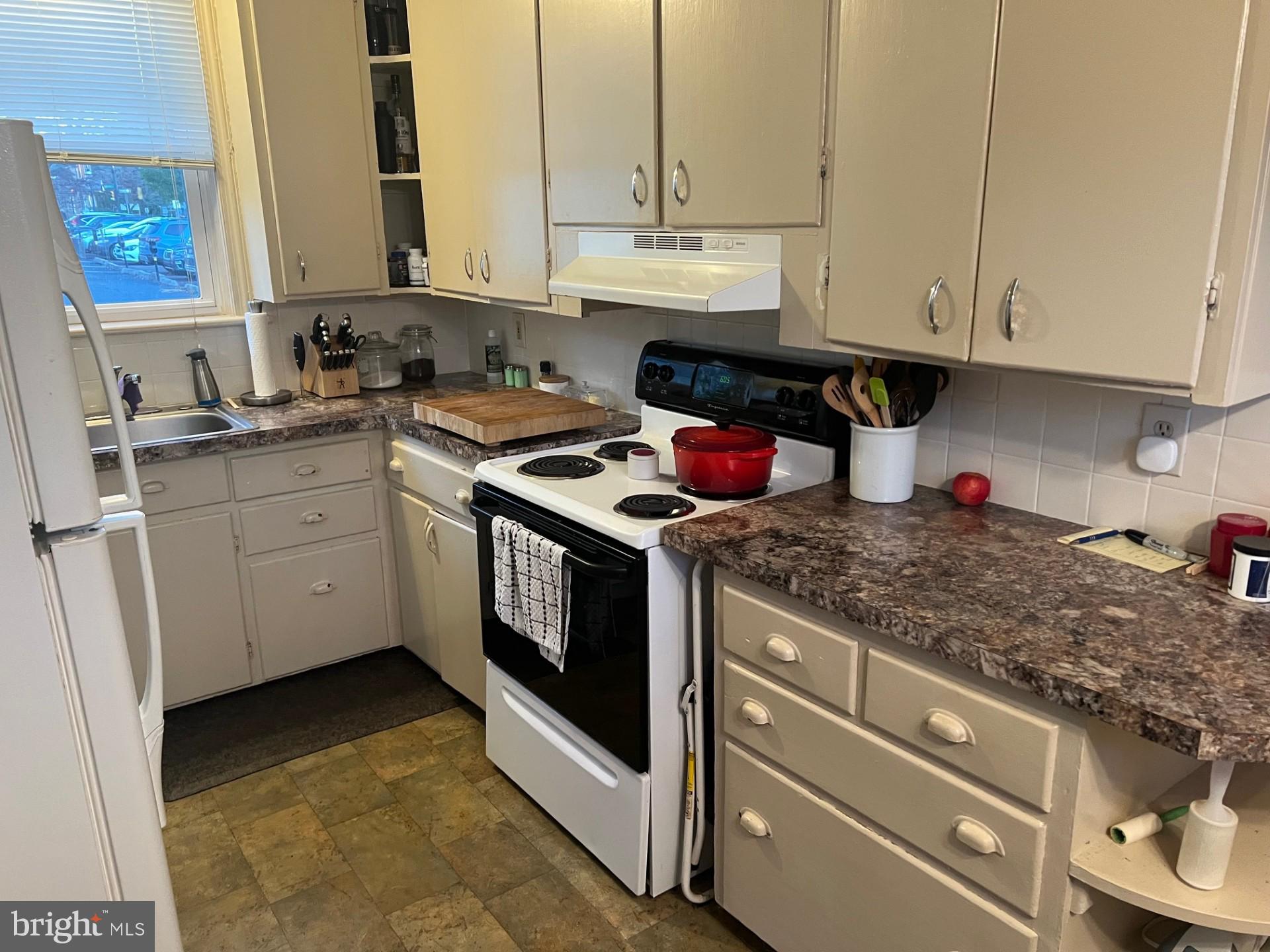 37 North Clinton Street, Unit A Doylestown, PA 18901 - Photo 7 of 11 a kitchen with stainless steel appliances granite countertop a stove sink and cabinets