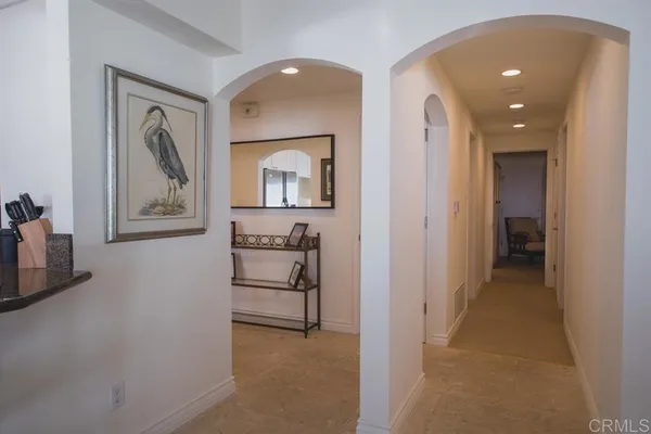 a view of a hallway to a livingroom and a couch