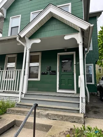 a front view of a house with a small garden