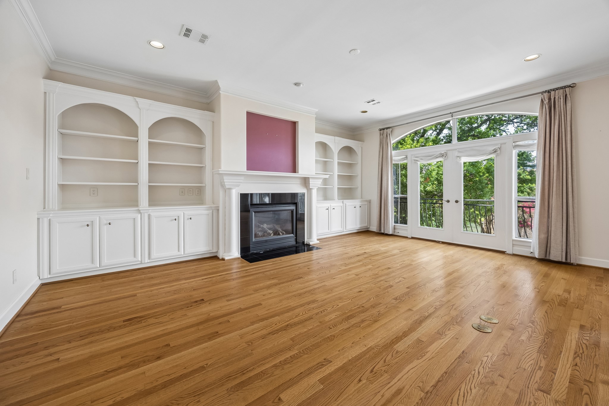 1119 Banks Street Houston, TX 77006 - Photo 8 of 27 This view shows the built-in bookshelves and gas log fireplace.