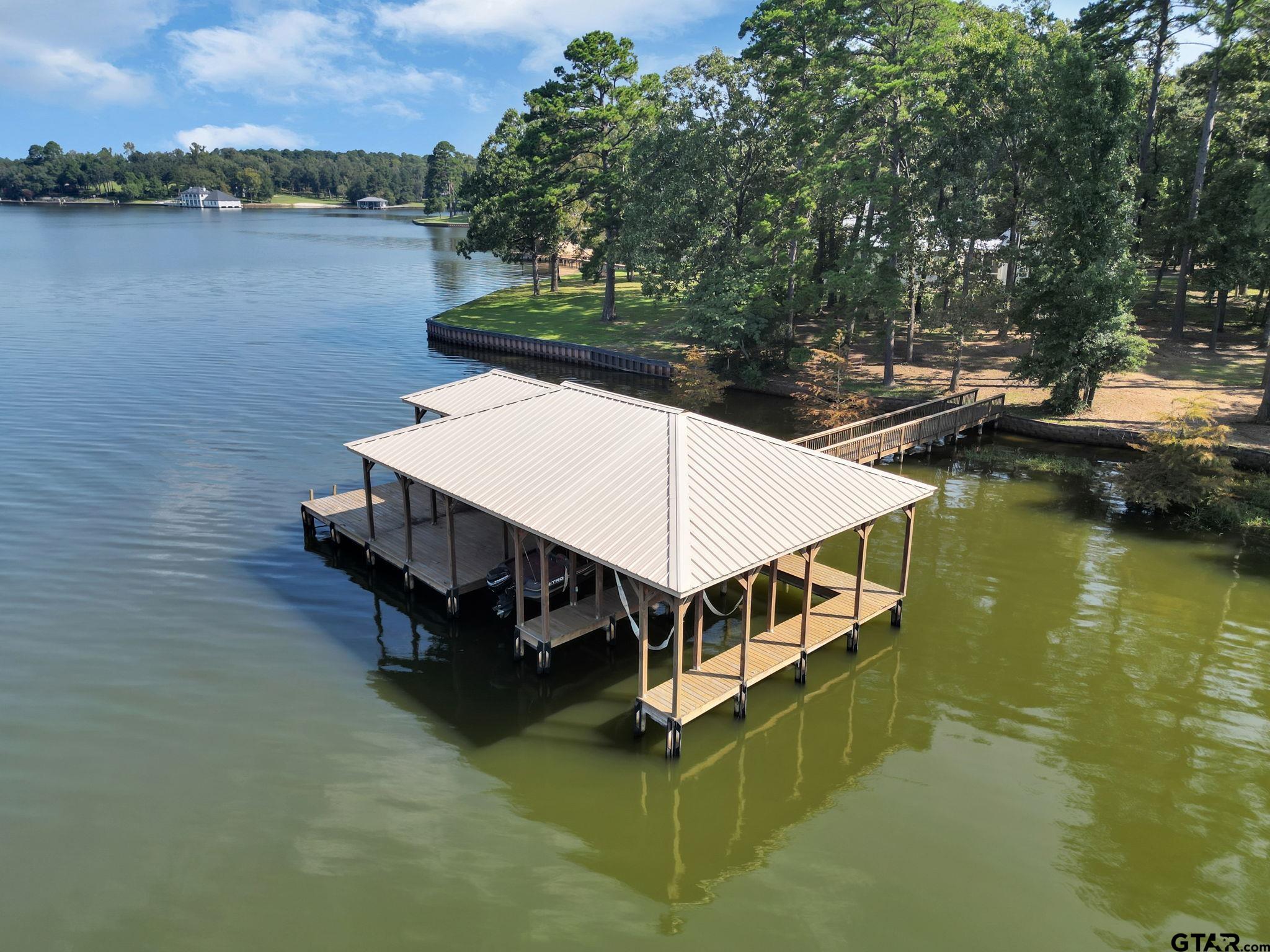 0 Eastside Road, Unit 3 Tyler, TX 75707 - Photo 28 of 33 a view of a house with pool and lake view