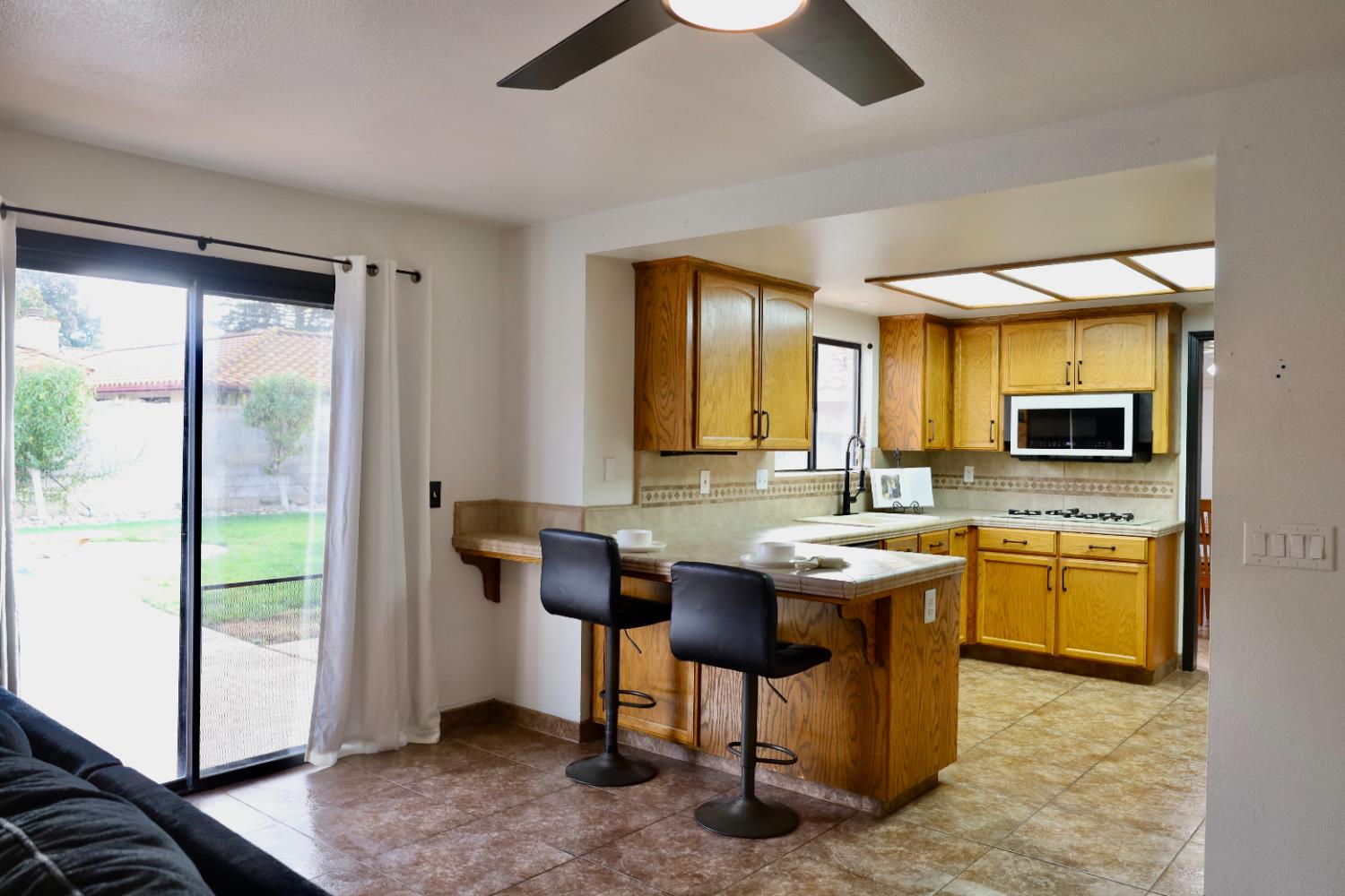 3040 Boulder Avenue Madera, CA 93637 - Photo 18 of 50 a kitchen with a sink and chairs