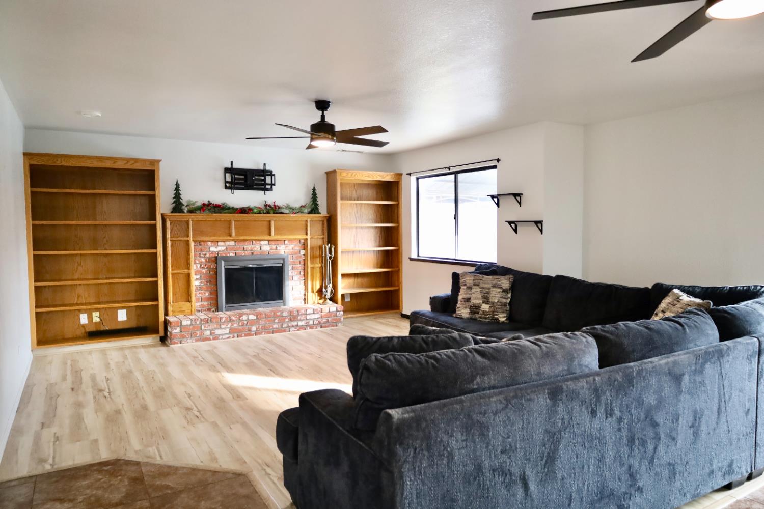 3040 Boulder Avenue Madera, CA 93637 - Photo 20 of 50 a living room with furniture and a fireplace