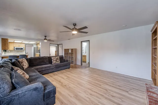 a bedroom with a bed and a ceiling fan