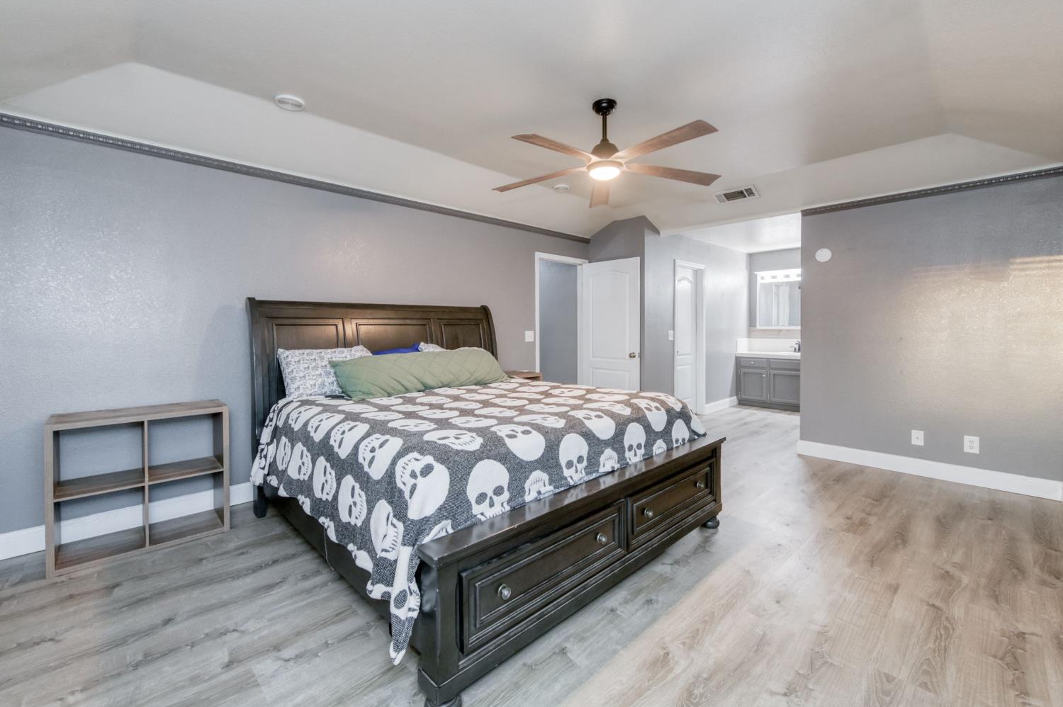 3040 Boulder Avenue Madera, CA 93637 - Photo 24 of 50 a bedroom with a bed and a ceiling fan