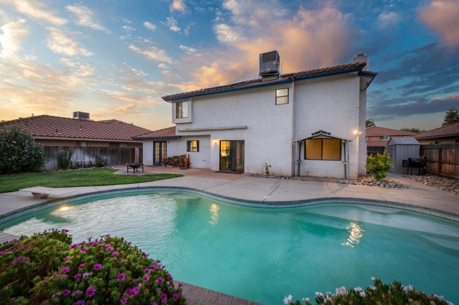 3040 Boulder Avenue Madera, CA 93637 - Photo 6 of 50 a front view of a house with a yard table and chairs